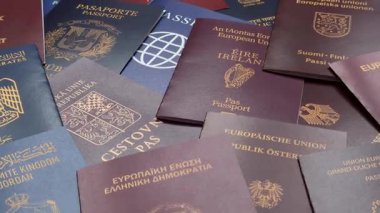 Farklı ülkelerin vatandaşlarının pasaportları, çeşitli ülkelerin pasaportlarından oluşan arka plan.