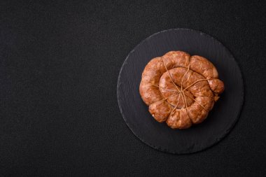 Spiral ya da salyangoz şeklinde ızgara sosis, baharat ve bitkilerle yapılmış tavuk ya da domuz eti yemeği. Dizaynınız için yemek arkaplanı olarak sarmal ya da salyangoz sosisi