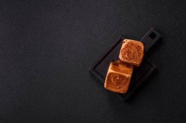 Çikolata dolgulu bir Fransız küp kruvasanı, tatlı bir kahvaltı pastası. Tasarımınız için yemek arkaplanı olarak küp kruvasan