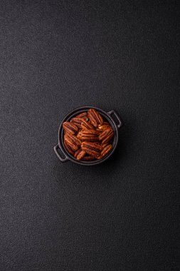 Peeled and roasted pecan nut as an ingredient for healthy foods and snacks. Pecan nut as a food background for your design.