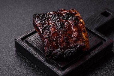 Grilled or barbecued pork or beef ribs, meat with red sauce, ready for the dinner table. Grilled ribs as a food background for your design