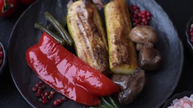 Mısır, dolmalık biber, kabak ve ızgara mantar gibi sebzelerin yanı sıra yemek masası için tuz ve baharat. Tasarımınız için yiyecek olarak ızgara sebze.