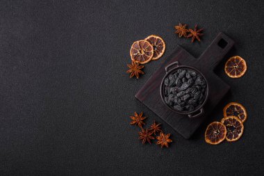 Sweet, dry black or blue raisins made from grapes are a healthy and nutritious food. Black raisins as a food background for your design