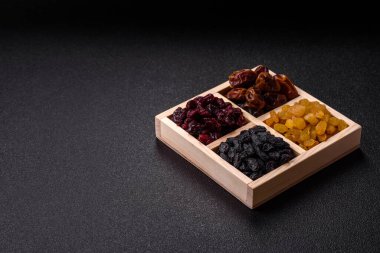 Dried fruits and berries, cranberries, dates, and raisins for a healthy diet. Dried berries and fruits as a food background for your design