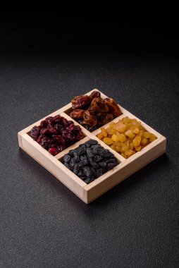 Dried fruits and berries, cranberries, dates, and raisins for a healthy diet. Dried berries and fruits as a food background for your design