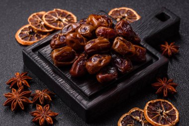Dried sweet dates, natural tropical fruits for a healthy diet. Dried dates as a food background for your design