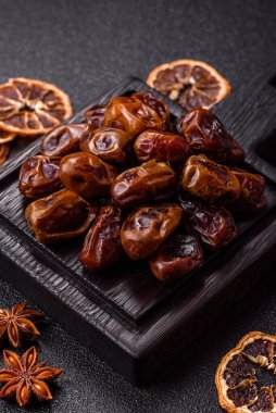 Dried sweet dates, natural tropical fruits for a healthy diet. Dried dates as a food background for your design