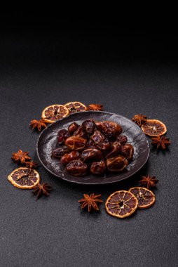 Dried sweet dates, natural tropical fruits for a healthy diet. Dried dates as a food background for your design