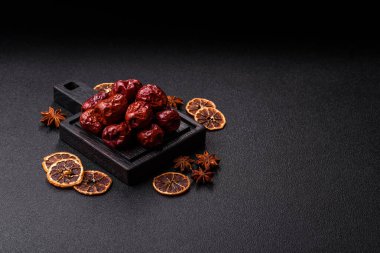 Red dried dates, the Chinese sweet fruit jujube, as a healthy food. Red dates, jujube as a food background for your design
