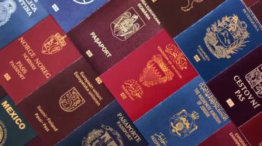 Farklı ülkelerin vatandaşlarının pasaportları, çeşitli ülkelerin pasaportlarından oluşan arka plan.