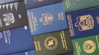 Farklı ülkelerin vatandaşlarının pasaportları, çeşitli ülkelerin pasaportlarından oluşan arka plan.