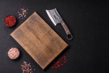 Yemek hazırlamak için bir bıçak, tuz ve baharatla boş tahta kesme tahtası. Tasarımınız için yiyecek arka planı olarak boş bir tahta kesme tahtası