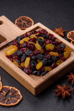 Kurutulmuş yaban mersini, sarı ve siyah tatlı üzümler granola ve kahvaltı malzemesi olarak kullanılıyor. Kuru üzümler ve kızılcıklar tasarımınız için gıda arka planı olarak kullanılıyor.