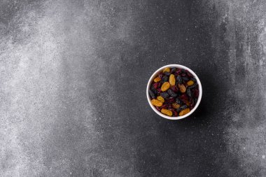 Kurutulmuş yaban mersini, sarı ve siyah tatlı üzümler granola ve kahvaltı malzemesi olarak kullanılıyor. Kuru üzümler ve kızılcıklar tasarımınız için gıda arka planı olarak kullanılıyor.