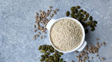 Kasedeki beyaz susam tohumları, yağ ve sağlıklı yemek için bir malzeme. Tasarımınız için yiyecek arka planı olarak beyaz susam