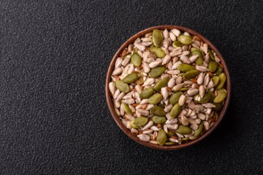 Sağlıklı yiyecekler için kabuklu ayçiçeği, susam, balkabağı ve keten tohumu çekirdekleri. Tasarımınız için gıda arka planı olarak tohumlar ve tahıllar.