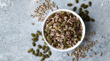 Sağlıklı yiyecekler için kabuklu ayçiçeği, susam, balkabağı ve keten tohumu çekirdekleri. Tasarımınız için gıda arka planı olarak tohumlar ve tahıllar.