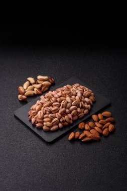 Sağlıklı, yüksek kalorili bir gıda malzemesi olarak kabuklu şam fıstığı. Tasarımınız için yemek arkaplanı olarak fıstıklar