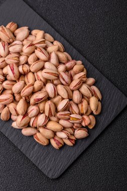 Sağlıklı, yüksek kalorili bir gıda malzemesi olarak kabuklu şam fıstığı. Tasarımınız için yemek arkaplanı olarak fıstıklar