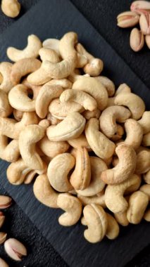 Kızarmış ya da çiğ kaju sağlıklı ve doyurucu bir yemek için lezzetli bir atıştırmalık olur. Tasarımınız için yemek arkaplanı olarak kaju fıstıkları