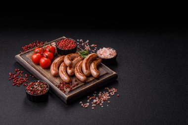 Grilled pork or chicken sausages, smoked fried food with salt and spices. Grilled sausages as a food background for your design