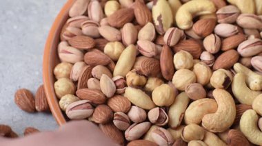 Sağlıklı gıda malzemesi olarak kaju, fıstık, badem, Brezilya fındığı, macadamia ve fındık karışımı. Tasarımınız için yemek arkaplanı olarak fındık