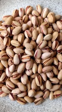 Sağlıklı, yüksek kalorili bir gıda malzemesi olarak kabuklu şam fıstığı. Tasarımınız için yemek arkaplanı olarak fıstıklar