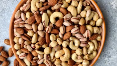 Sağlıklı gıda malzemesi olarak kaju, fıstık, badem, Brezilya fındığı, macadamia ve fındık karışımı. Tasarımınız için yemek arkaplanı olarak fındık