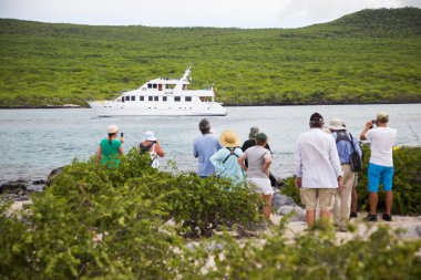 Yacht in Galapagos and tourists clipart