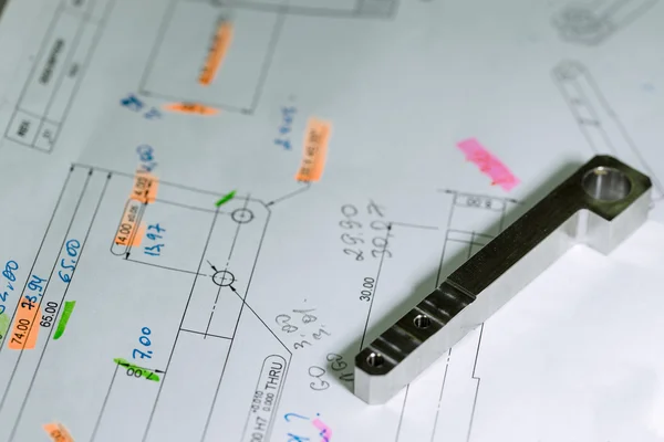 Ready CNC metal detail on technical drawing sketch with measures — Stock Photo, Image