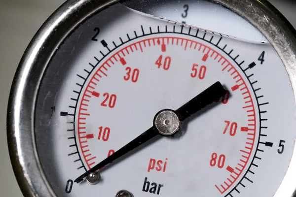 Manometer turbo pressure meter gauge in pipes oil plant with liquid inside — Stock Photo, Image