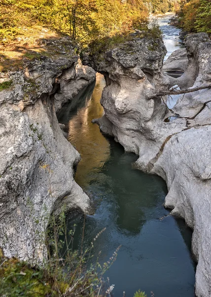 Rapid mountain river washed in lime line with bizarre twists. — Stock Image Rapid mountain river washed in lime line with bizarre twists. Royalty Free Stock Photos