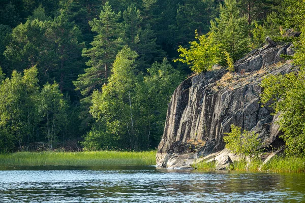 beautiful landscape with green, natural trees and plants, rocks on the island, natural pond, lake in Karelia, Russia