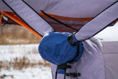 Parlak renklerle boyanmış pervaneli küçük bir uçak ya havaalanında ya da kışın karda havaalanında.