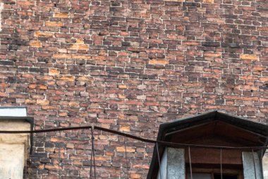 brown brick wall, roof and attic of an old building in a big city