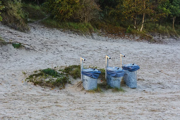 Three trash tank on the sand near the forest — Stock Photo, Image