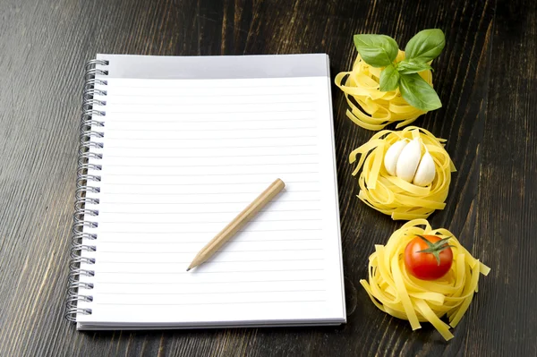 Pasta with blank recipe book — Stock Photo, Image