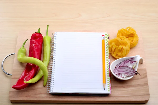 Blank recipe book with pasta,pepper, onion — Stock Photo, Image