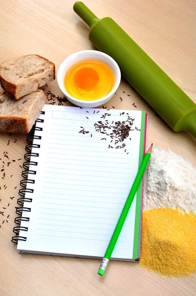 Blank recipe book with bread, egg, flour, corn flour, cumin — Stock Photo, Image
