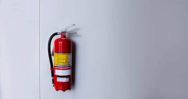 The red fire extinguisher is ready for use in case of an indoor fire emergency.