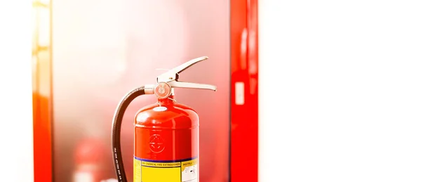 The red fire extinguisher is ready for use in case of an indoor fire emergency.