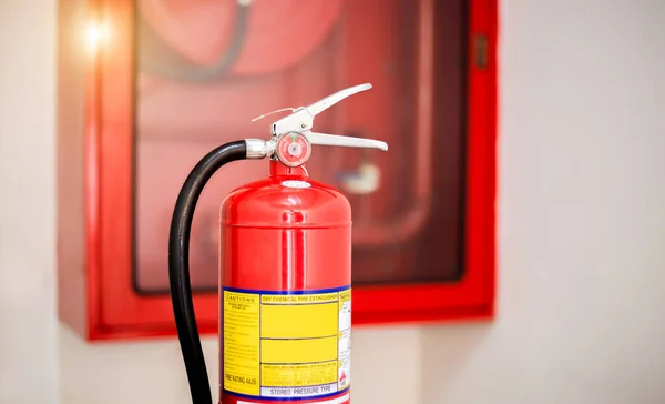 The red fire extinguisher is ready for use in case of an indoor fire emergency.