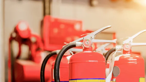 The red fire extinguisher is ready for use in case of an indoor fire emergency.