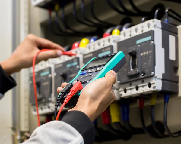 An electrical engineer is investigating an electrical control cabinet maintenance concept.