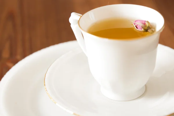 Vintage kopp te med rosenknoppar, på brun bakgrund — Stockfoto