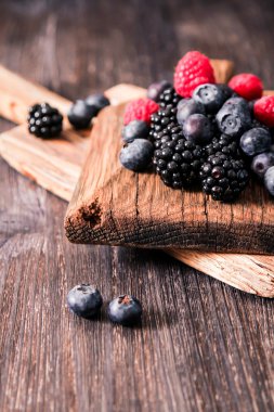 yaban mersini ve ahududu ahşap arka plan üzerinde