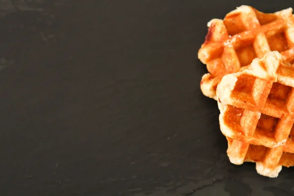 Belgian waffles on a wooden background — Stock Photo, Image
