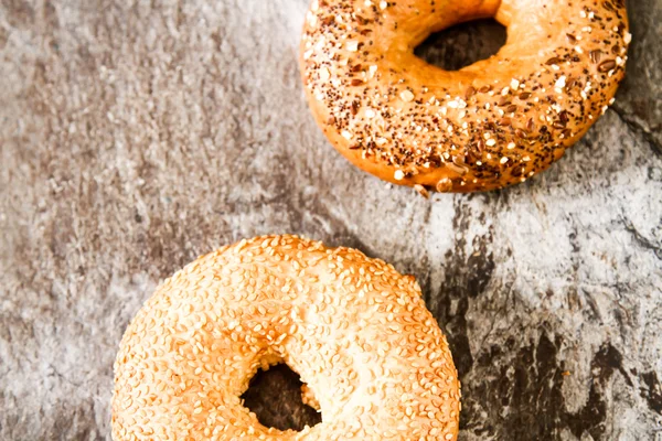 Fresh bagel on a stone background — Stock Photo, Image