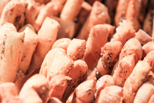 Palitos de pan crujientes con sal y romero fresco a bordo oscuro . — Foto de Stock