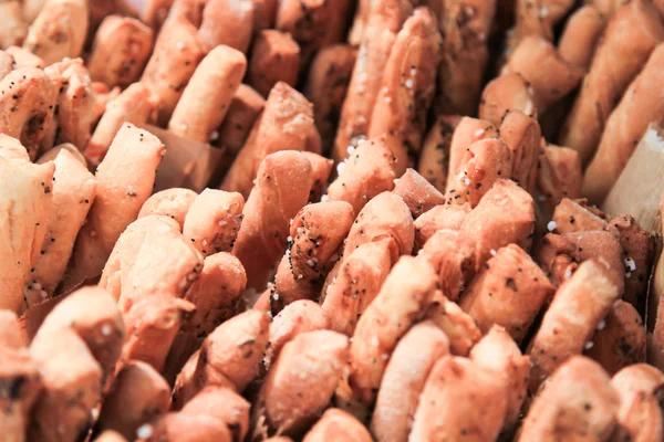 Palitos de pan crujientes con sal y romero fresco a bordo oscuro . — Foto de Stock